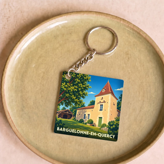 Porte-clés souvenir de la commune de Barguelonne-en-Quercy avec une illustration stylisée d'une demeure traditionnelle.