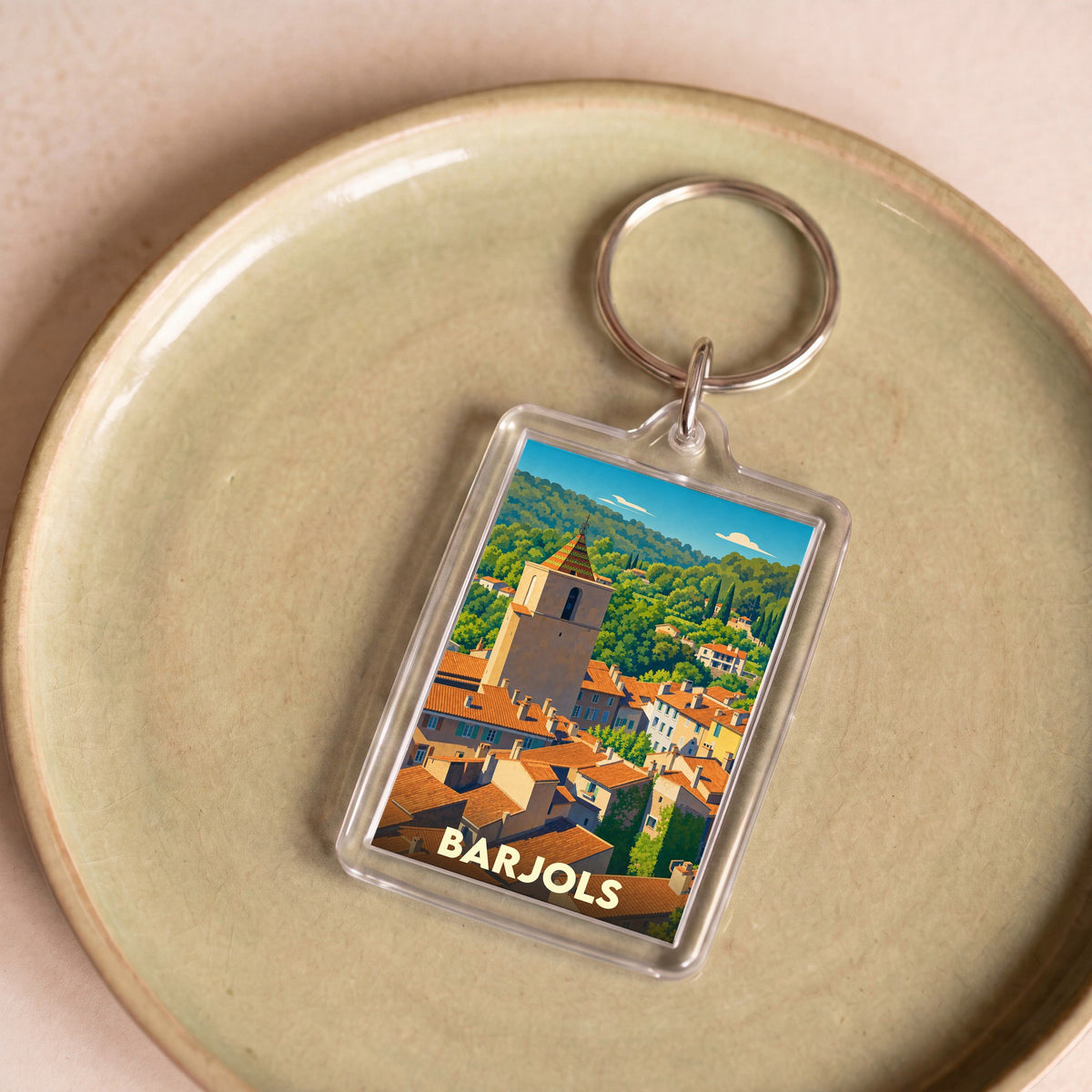 Porte-clés souvenir de la ville de Barjols avec une illustration stylisée de ses toits provençaux.