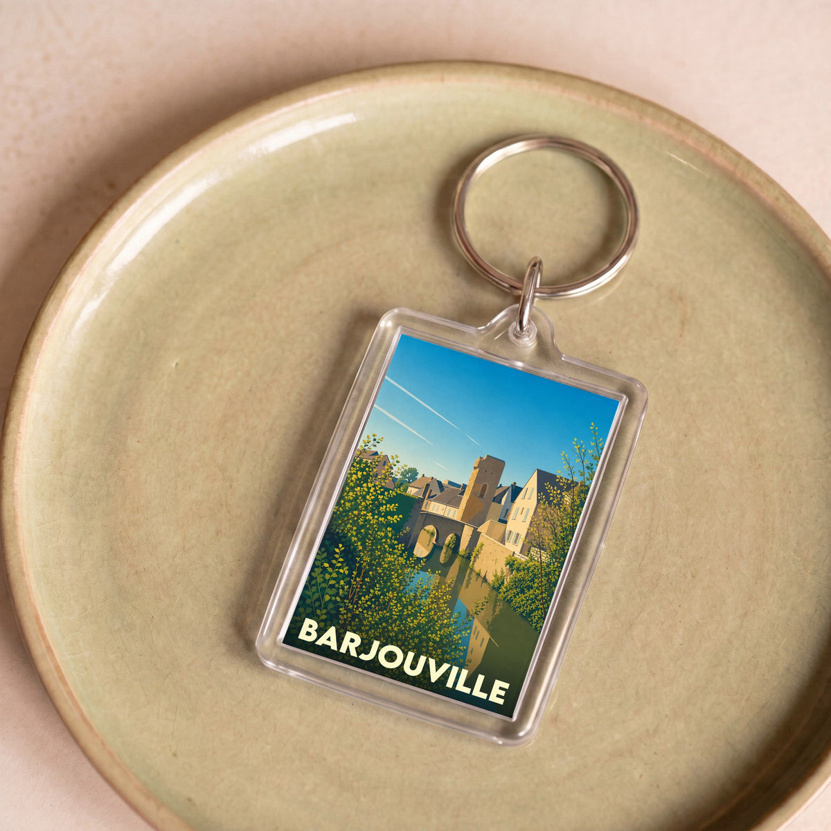 Porte-clés souvenir de la ville de Barjouville avec une illustration stylisée.