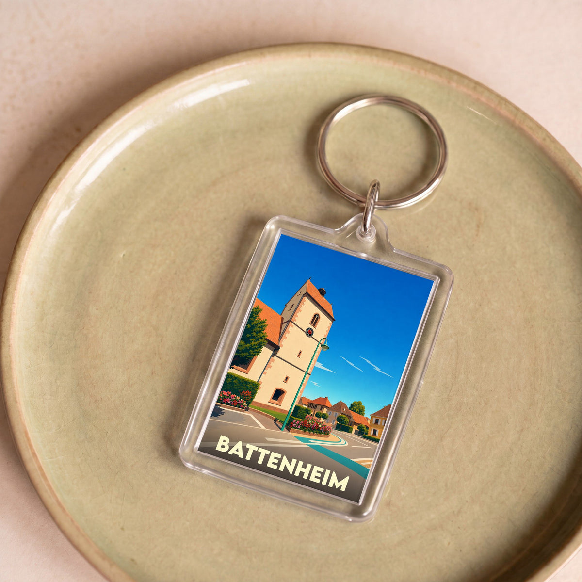 Porte-clés souvenir de la ville de Battenheim avec une illustration stylisée de son église.