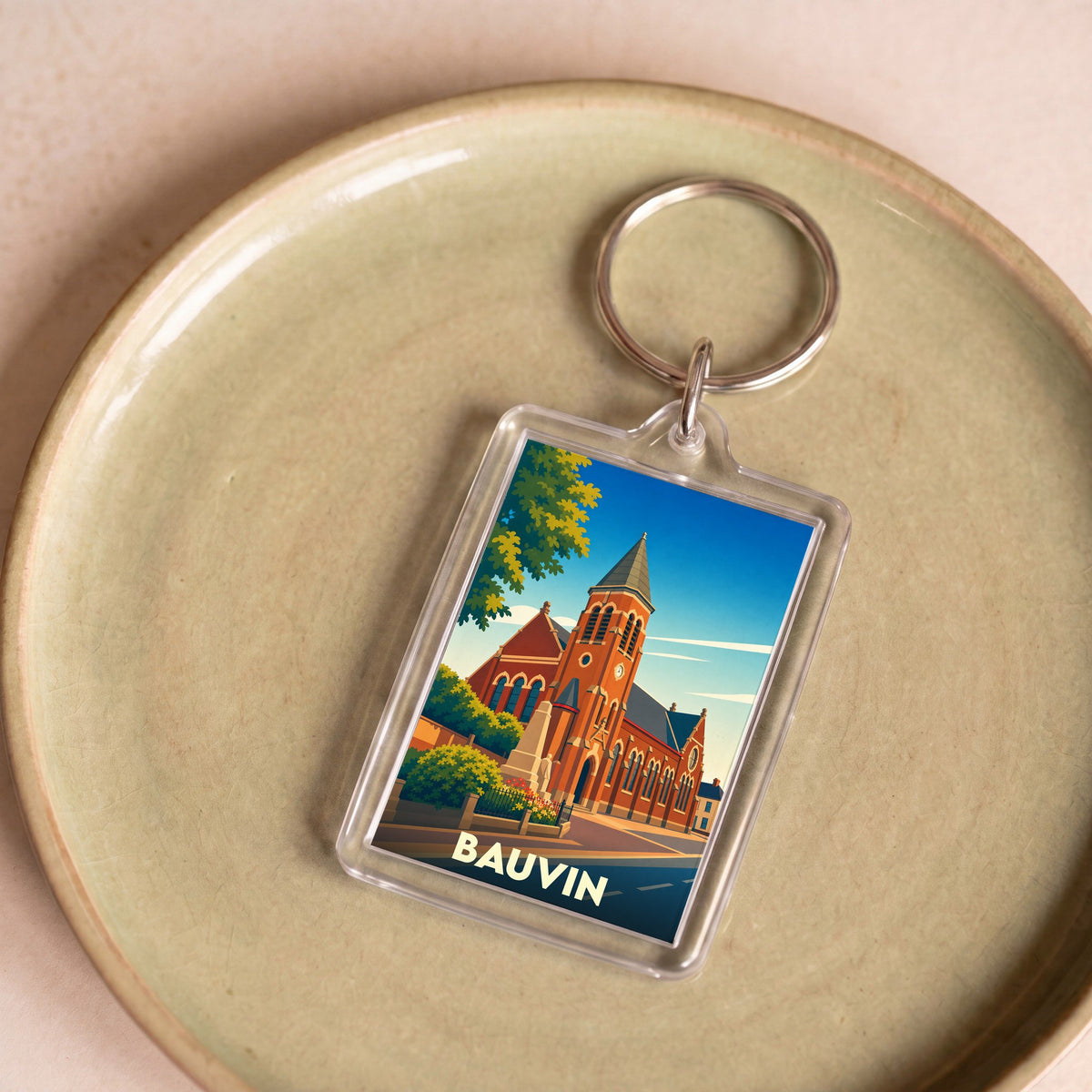 Porte-clés souvenir de la ville de Bauvin avec une illustration stylisée de son église.