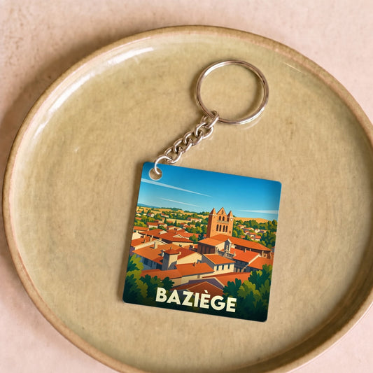Porte-clés souvenir de la ville de Baziège avec une illustration stylisée.
