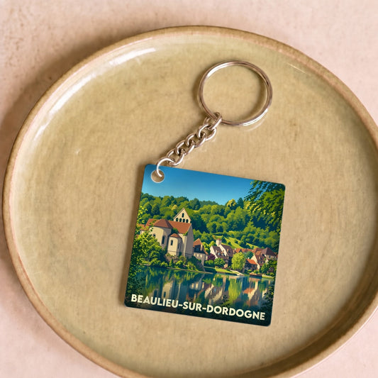 Porte-clés souvenir de la ville de Beaulieu-sur-Dordogne avec une illustration stylisée.