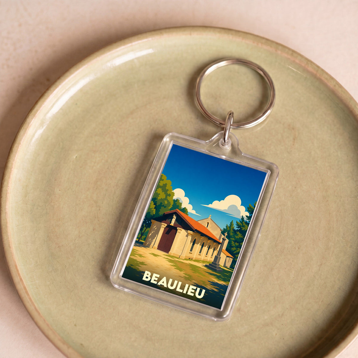 Porte-clés souvenir de la ville de Beaulieu avec une illustration stylisée.