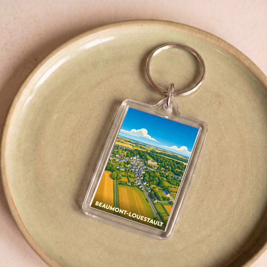 Porte-clés souvenir de la ville de Beaumont-Louestault avec une illustration stylisée.