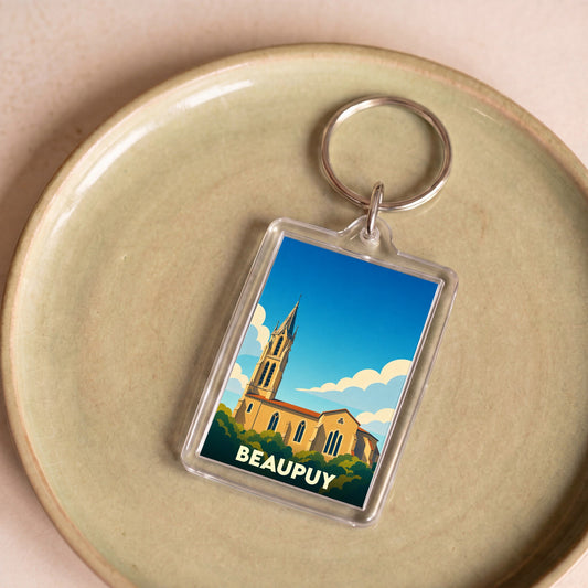 Porte-clés souvenir de la ville de Beaupuy avec une illustration stylisée de son église.