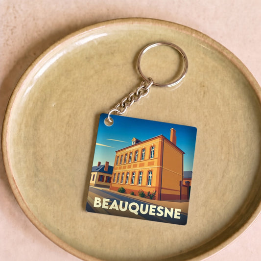 Porte-clés souvenir de la ville de Beauquesne avec une illustration stylisée.