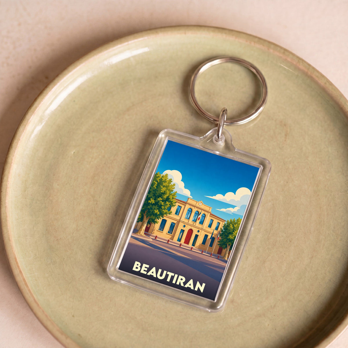 Porte-clés souvenir de la ville de Beautiran avec une illustration stylisée.