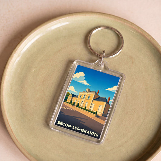 Porte-clés souvenir de la ville de Bécon-les-Granits avec une illustration stylisée de sa mairie.