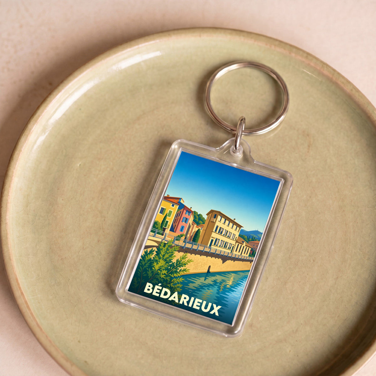 Porte-clés souvenir de la ville de Bédarieux avec une illustration stylisée.