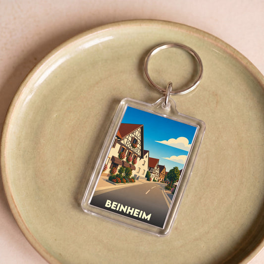 Porte-clés souvenir de la ville de Beinheim avec une illustration stylisée de ses maisons à colombages.