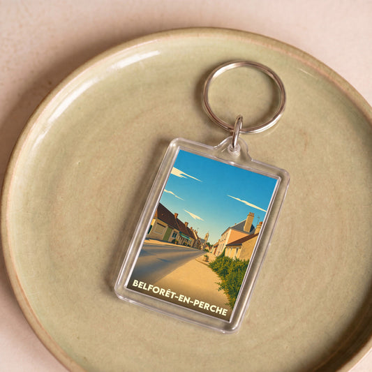Porte-clés souvenir de Belforêt-en-Perche avec une illustration stylisée de la ville.
