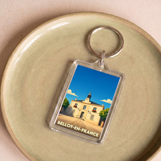 Porte-clés souvenir de la ville de Belloy-en-France avec une illustration stylisée de sa mairie.