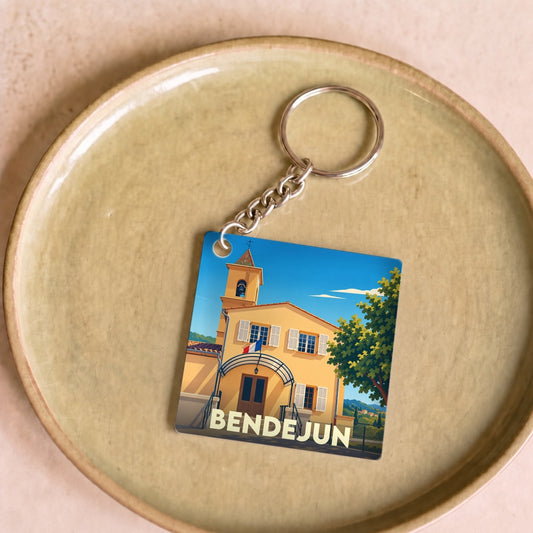 Porte-clés souvenir de la ville de Bendejun avec une illustration stylisée.