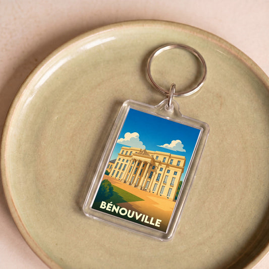 Porte-clés souvenir de la ville de Bénouville avec une illustration stylisée de son château.