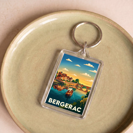 Porte-clés souvenir de la ville de Bergerac avec une illustration stylisée de son paysage fluvial.