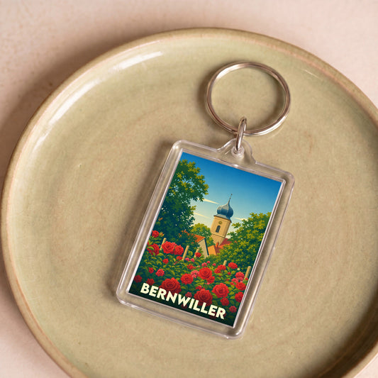 Porte-clés souvenir de la ville de Bernwiller avec une illustration stylisée d'une église et de roses.