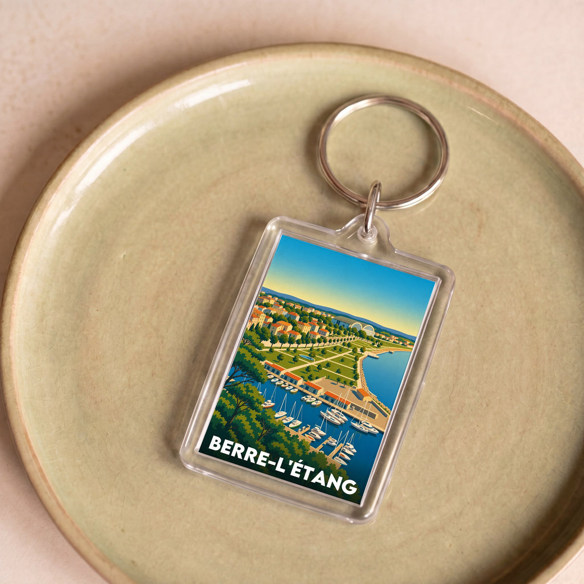 Porte-clés souvenir de la ville de Berre-l'Étang avec une illustration stylisée.