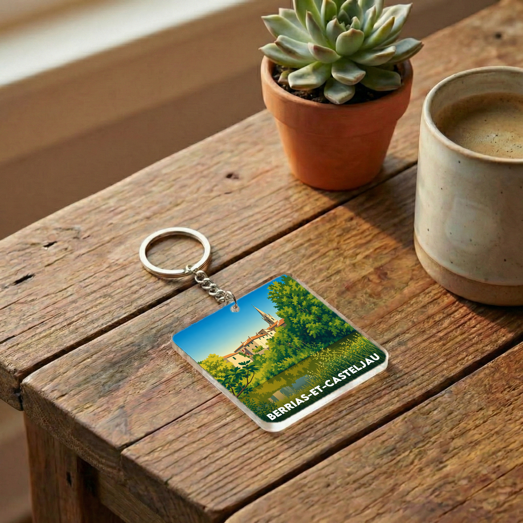 Porte-clés souvenir de la ville de Berrias-et-Casteljau avec une illustration stylisée du paysage local.
