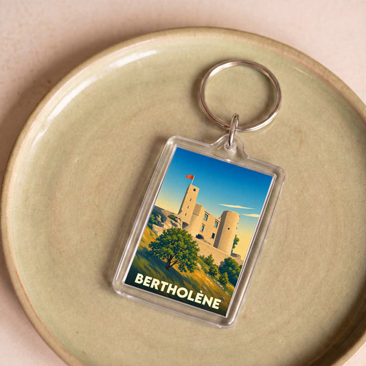 Porte-clés souvenir de la ville de Bertholène avec une illustration stylisée de son château.