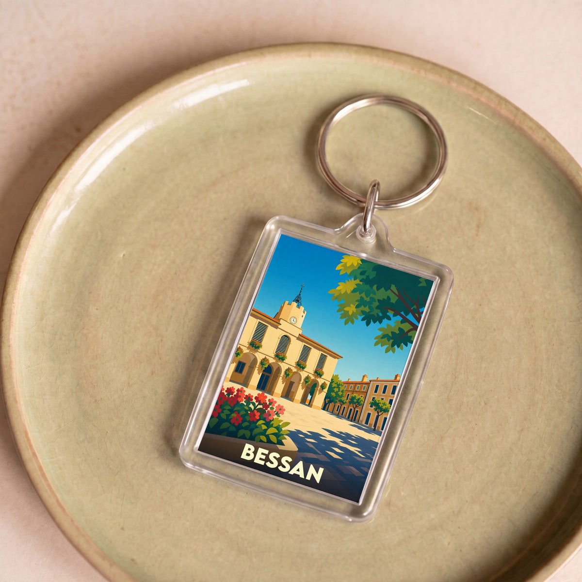 Porte-clés souvenir de la ville de Bessan avec une illustration stylisée de sa mairie.