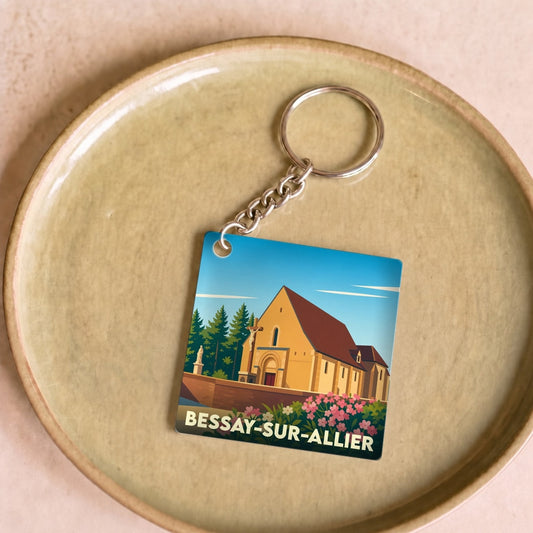 Porte-clés souvenir de la ville de Bessay-sur-Allier avec une illustration stylisée de son église.