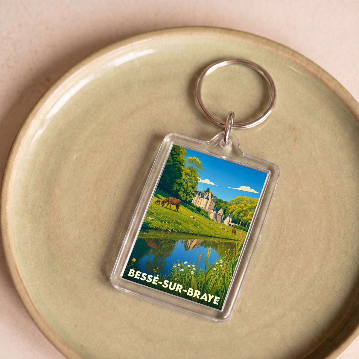 Porte-clés souvenir de la ville de Bessé-sur-Braye avec une illustration stylisée.