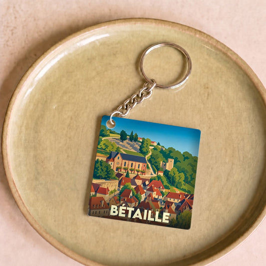 Porte-clés souvenir de la ville de Bétaille avec une illustration stylisée.