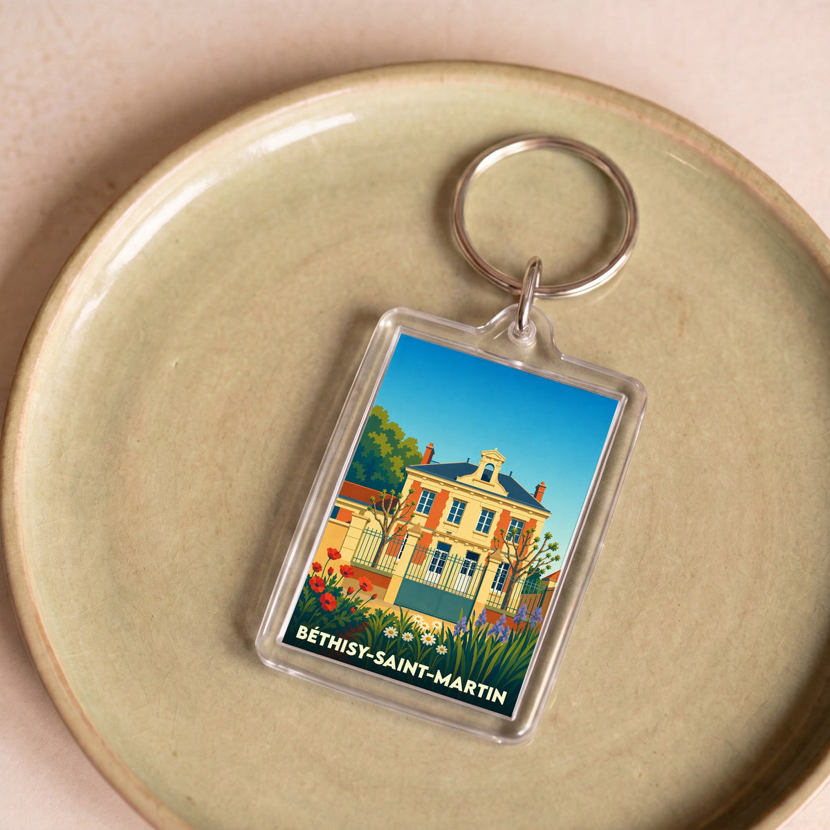 Porte-clés souvenir de la ville de Béthisy-Saint-Martin avec une illustration stylisée d'un bâtiment historique.