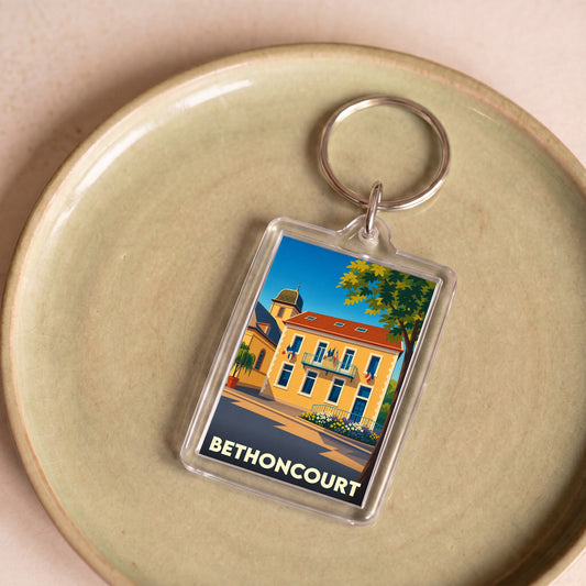 Porte-clés souvenir de la ville de Bethoncourt avec une illustration stylisée.