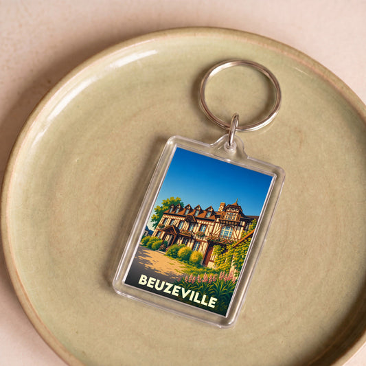Porte-clés souvenir de la ville de Beuzeville avec une illustration stylisée d'une maison normande à colombages.