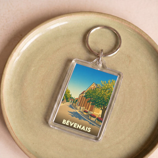 Porte-clés souvenir de la ville de Bévenais avec une illustration stylisée.