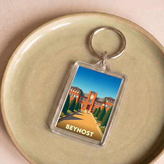 Porte-clés souvenir de la ville de Beynost avec une illustration stylisée.
