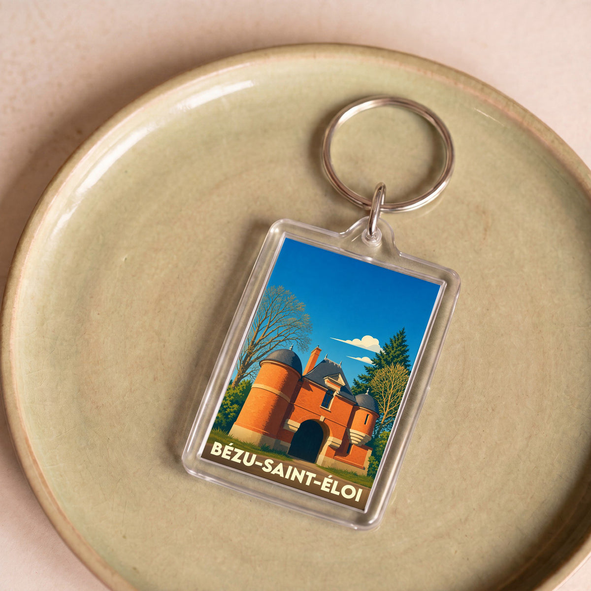 Porte-clés souvenir de la ville de Bézu-Saint-Éloi avec une illustration stylisée.
