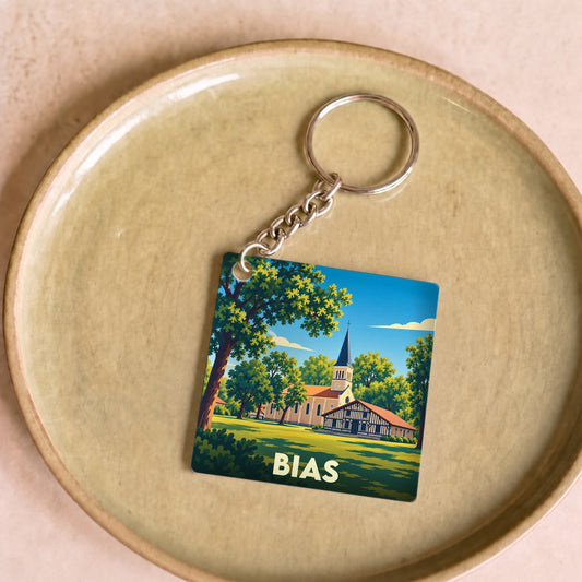 Porte-clés souvenir de la ville de Bias avec une illustration stylisée d'une église landaise.