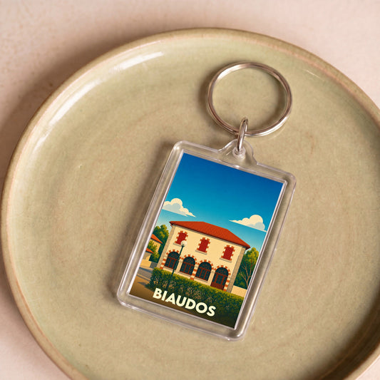 Porte-clés souvenir de la ville de Biaudos avec une illustration stylisée.