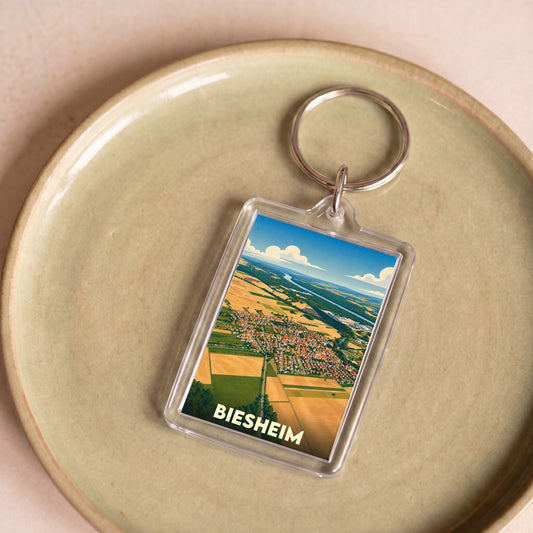 Porte-clés souvenir de la ville de Biesheim avec une illustration aérienne stylisée.