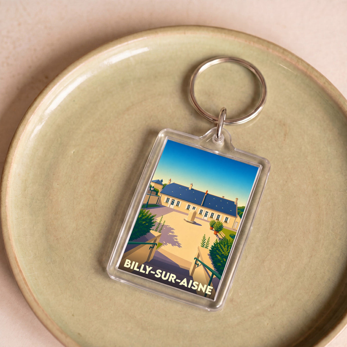 Porte-clés souvenir de la ville de Billy-sur-Aisne avec une illustration stylisée.
