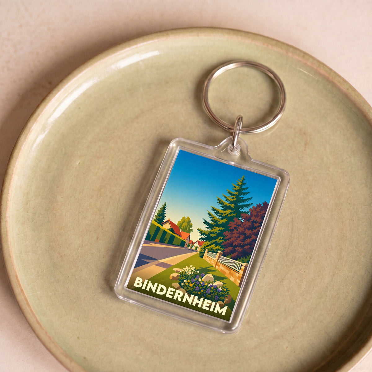 Porte-clés souvenir de la ville de Bindernheim avec une illustration stylisée de ses paysages.