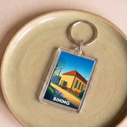 Porte-clés souvenir de la ville de Bining avec une illustration stylisée.