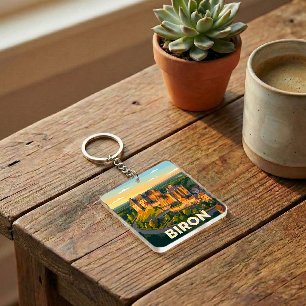 Porte-clés souvenir de la ville de Biron avec une illustration stylisée.