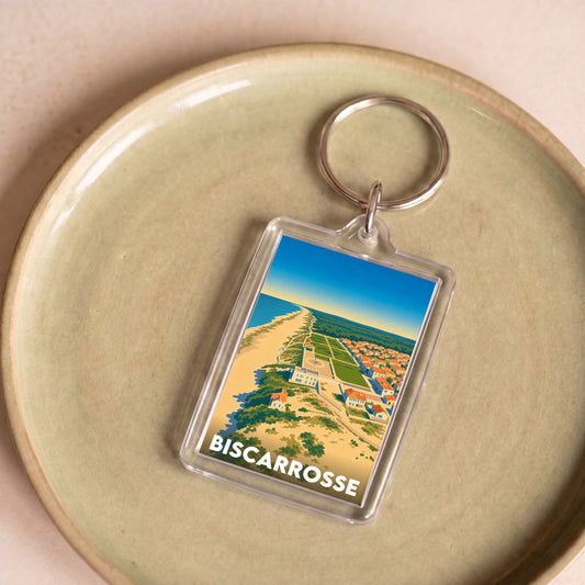 Porte-clés souvenir de la ville de Biscarrosse avec une illustration stylisée de son littoral.