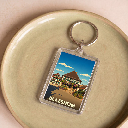 Porte-clés souvenir de la ville de Blaesheim avec une illustration stylisée de maisons à colombages.