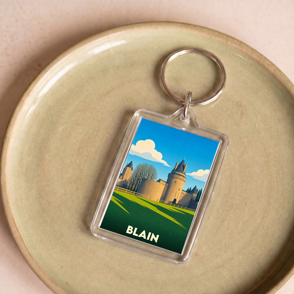 Porte-clés souvenir de la ville de Blain avec une illustration stylisée de son château.