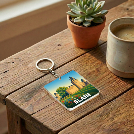 Porte-clés souvenir de la ville de Blain avec une illustration stylisée d'un château.