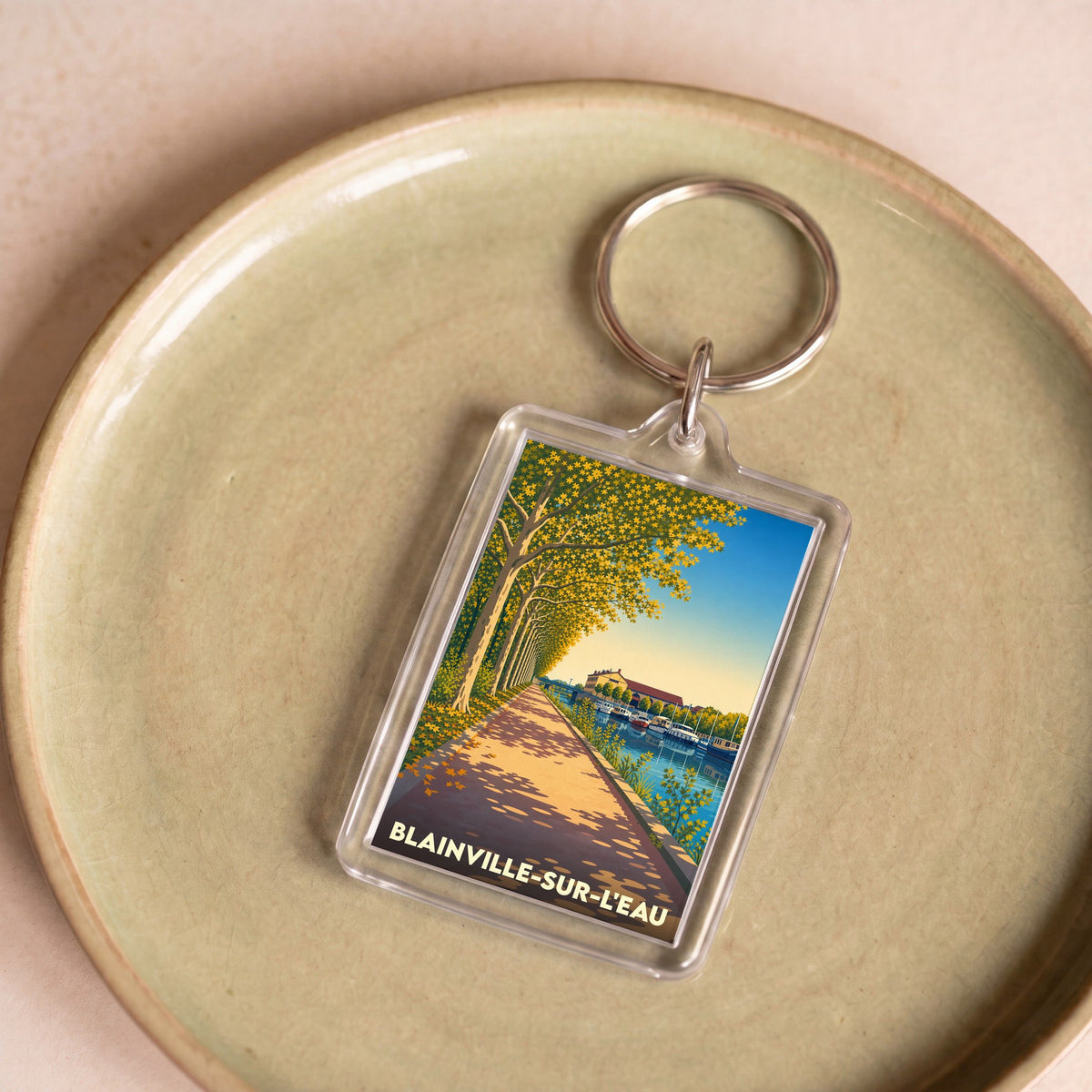 Porte-clés souvenir de la ville de Blainville-sur-l'Eau avec une illustration stylisée.