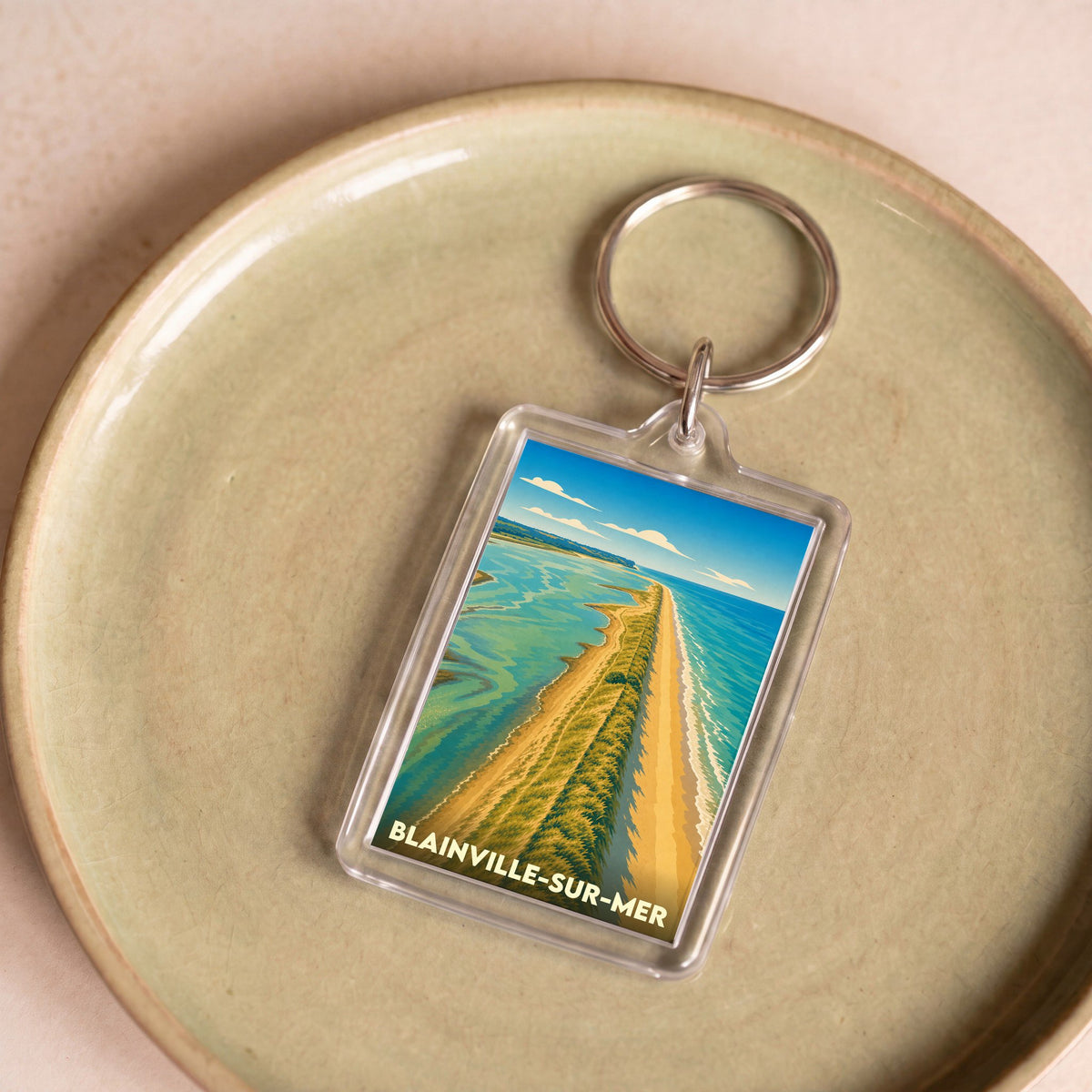 Porte-clés souvenir de la ville de Blainville-sur-Mer avec une illustration stylisée de son littoral.