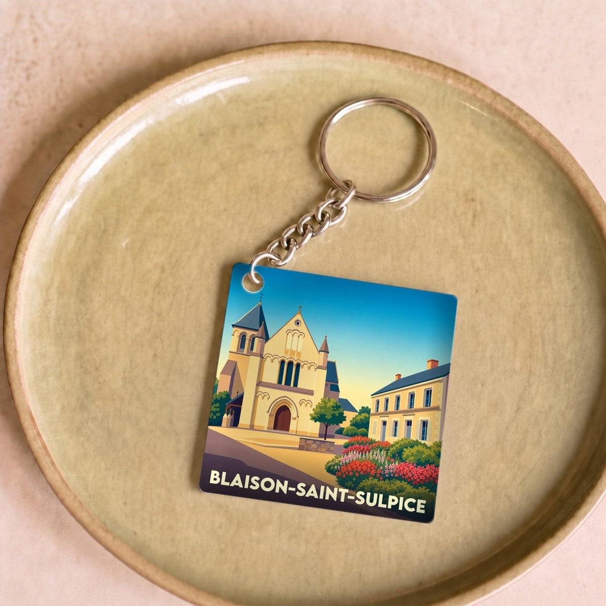 Porte-clés souvenir de la ville de Blaison-Saint-Sulpice avec une illustration stylisée.