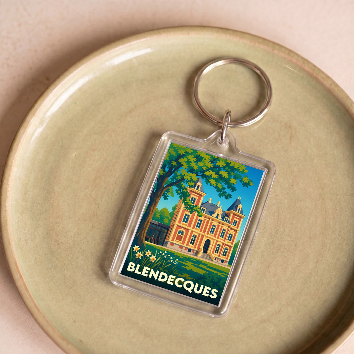 Porte-clés souvenir de la ville de Blendecques avec une illustration stylisée d'un château.