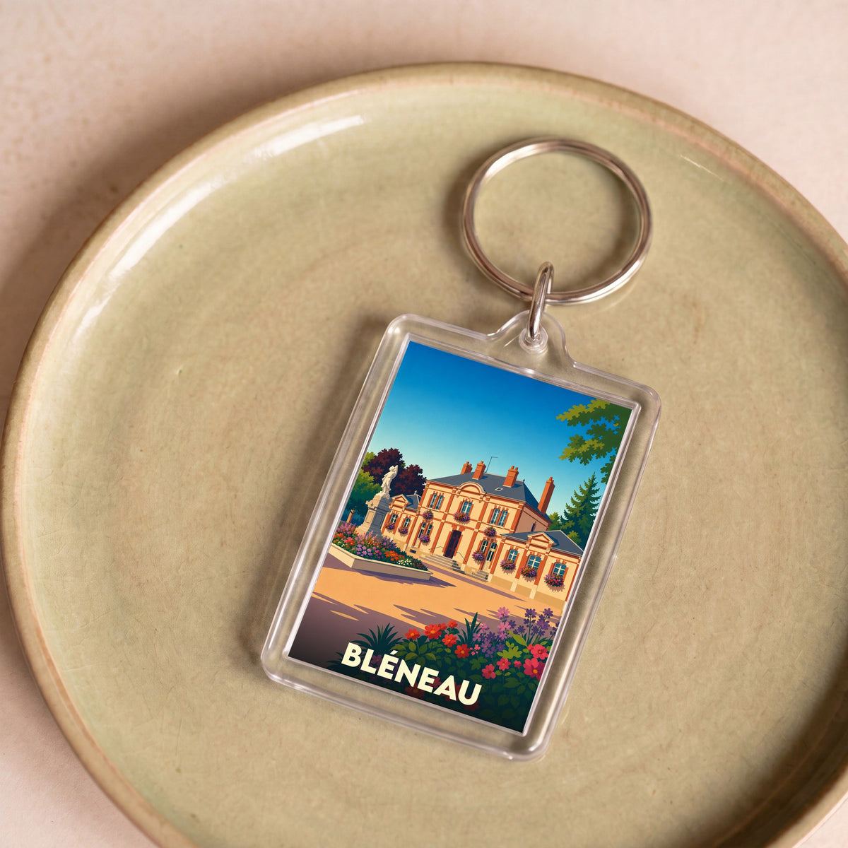 Porte-clés souvenir de la ville de Bléneau avec une illustration stylisée.